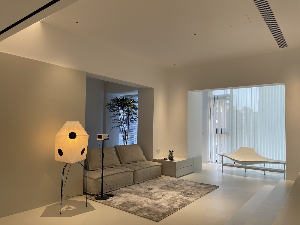Architectural lighting with 1 inch recessed ceiling spotlights highlighting artwork in a modern living room
