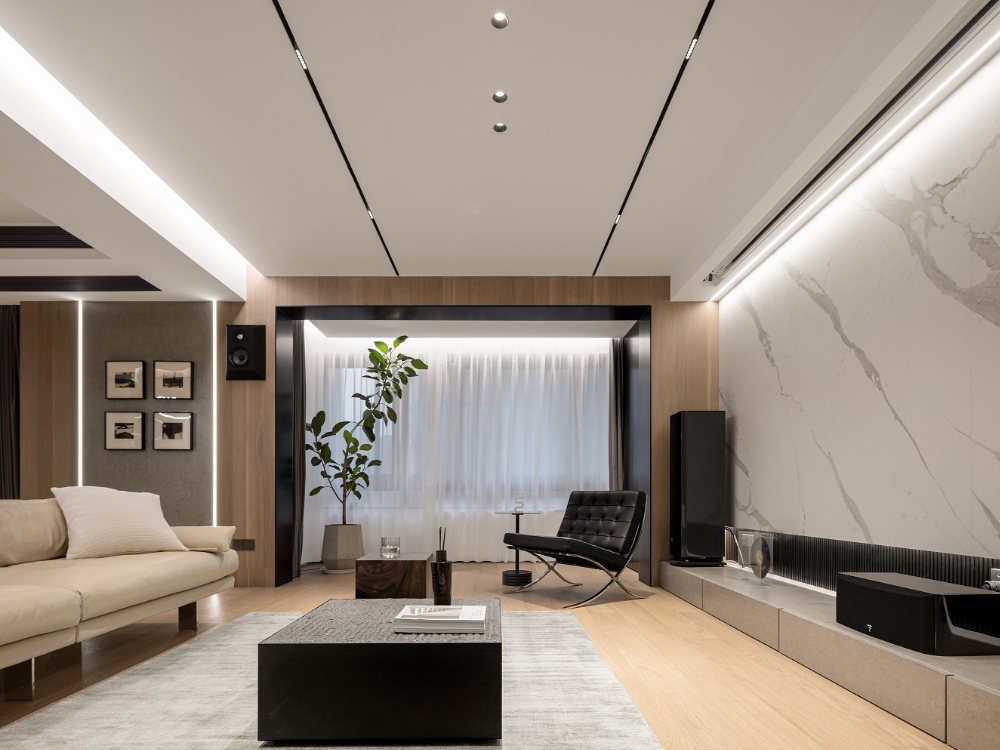 Layered lighting design with recessed LED lights and magnetic track spotlights in a modern interior