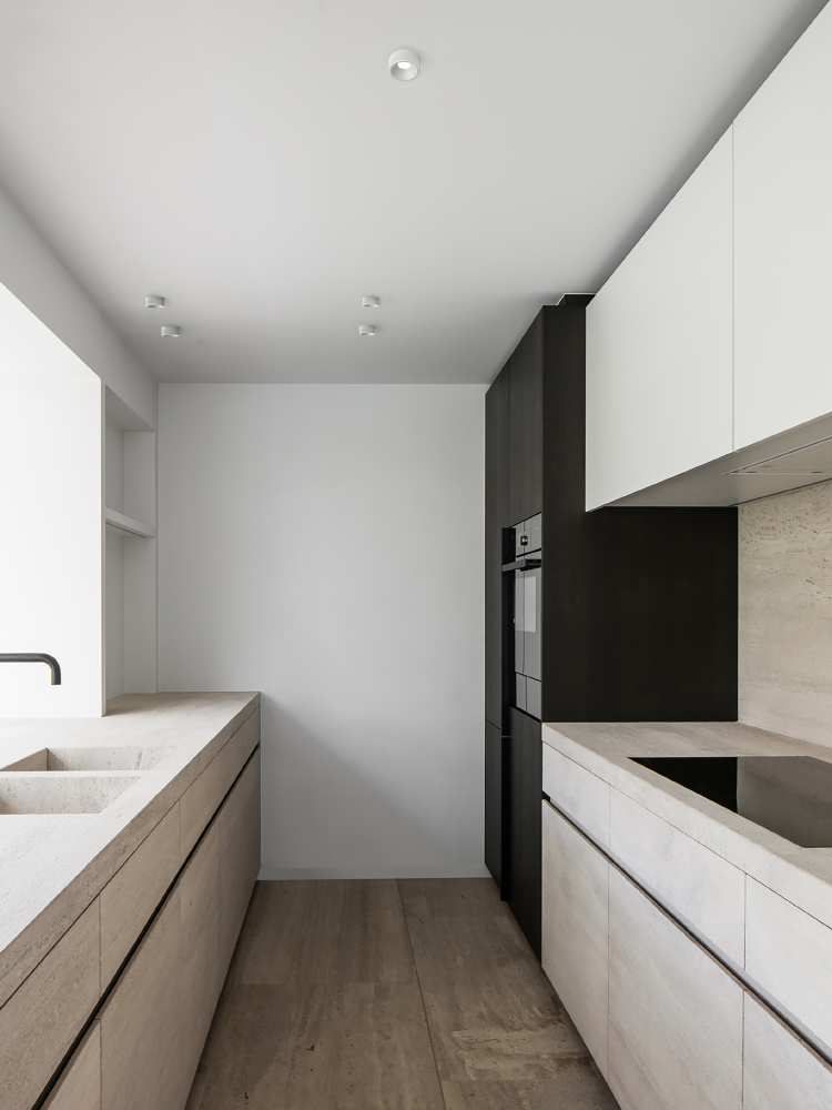 Semi-recessed downlight installed in a contemporary kitchen, combining ceiling accent lighting with a minimalist interior style